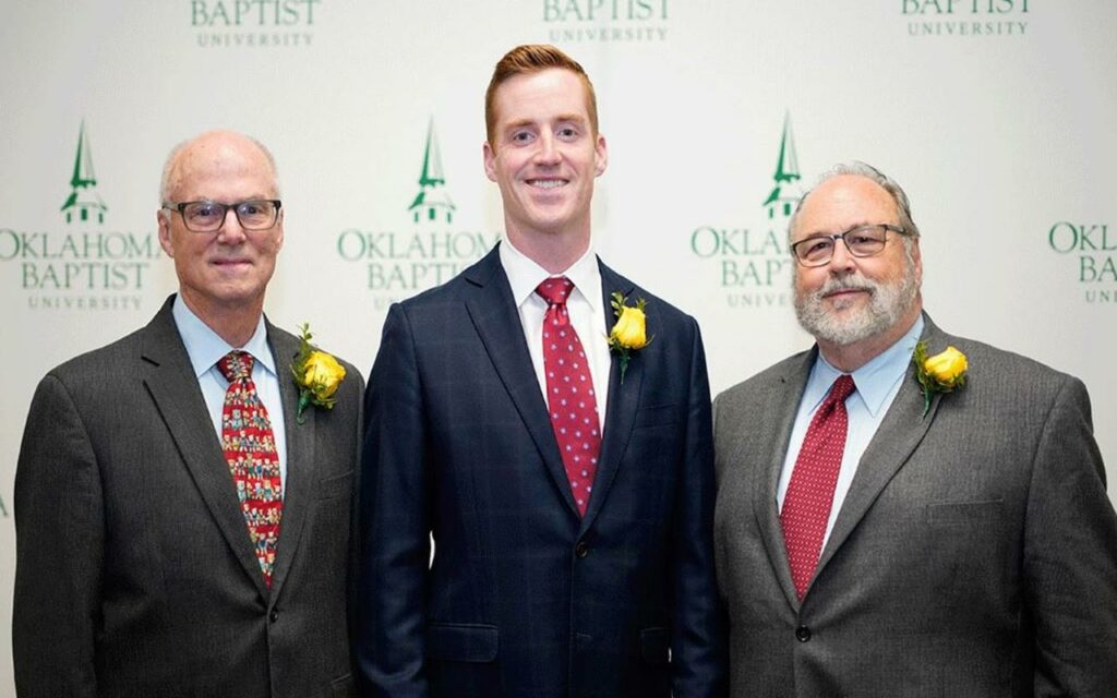 Peter Wilson standing with colleagues at the Oklahoma Baptist University awards ceremony