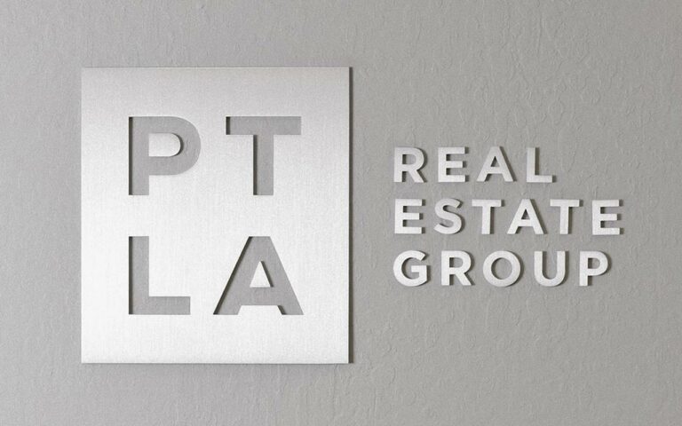 PTLA Real Estate Group logo against stone background